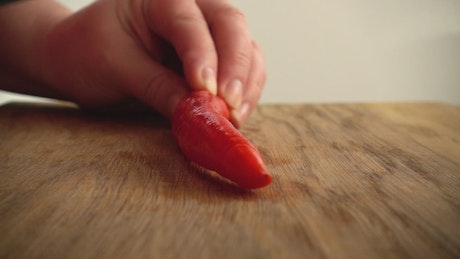 Cutting up a pepper for cooking.
