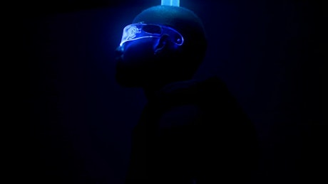 Cyberpunk dancer poses under neon laser lights.