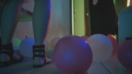 Dancing and playing with balloons at a costume party.