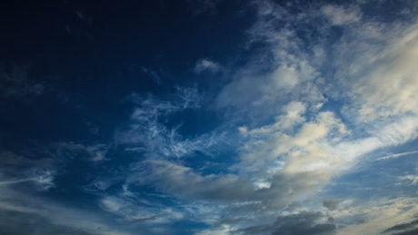 Dark blue sky above morning clouds