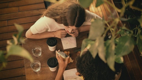 Date between two girl friends in a coffee shop.