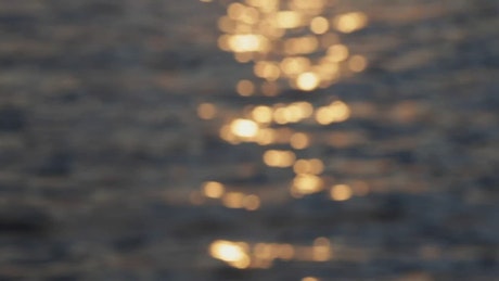 Defocused view of the sunset reflection in the sea