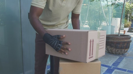 Delivering a package to a woman at home.