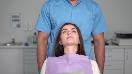 Dentist examines woman's teeth