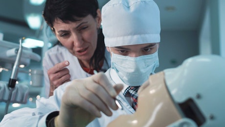 Dentist student practicing on a dummy