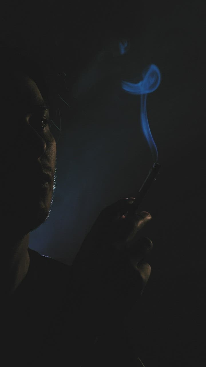  888slot Depressed guy smoking in the dark