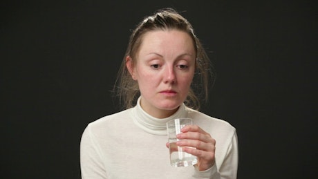 Depressed woman drinking water