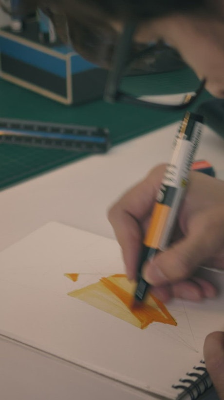 Designer coloring changing of drawing utensil.