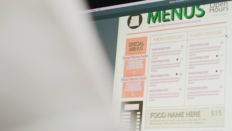 Designing a restaurant menu in a professional graphics design software.