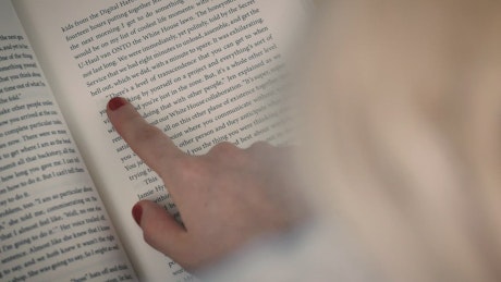 Detailed view of a book read by a girl.