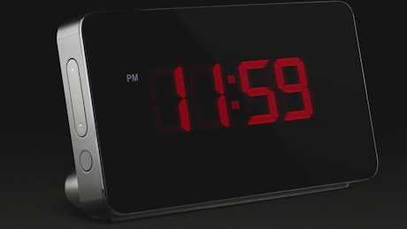 Digital clock in the dark marking midnight.