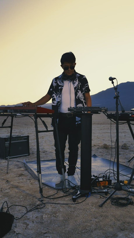 Dj giving a concert in a lonely desert.
