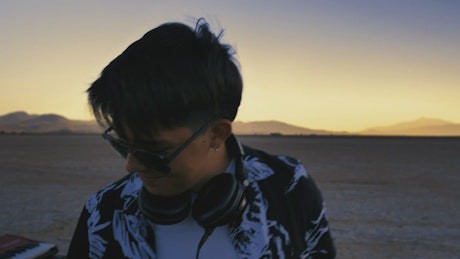 Dj mixing electronic music in a lonely desert