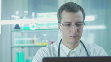 Doctor in the lab looking at the computer screen