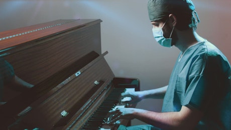 Doctor plays piano after a long day at work.