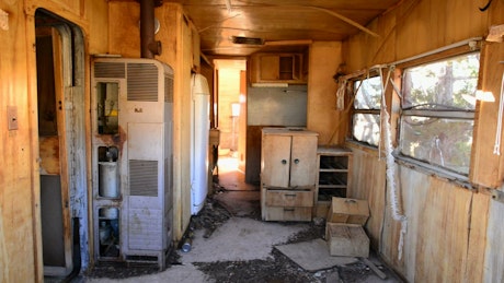 Dolly in of an interior of abandoned trailer.