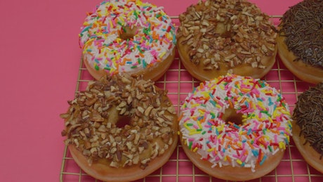 Donuts with various types of icing in a close up shot.