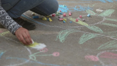 Drawing with chalk on a path.