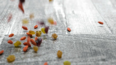 Dried fruit falling onto a table.