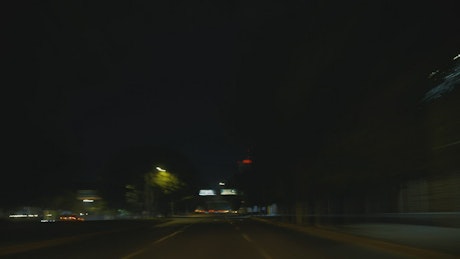Driving down an avenue at night