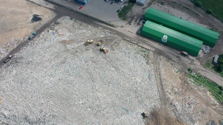 Drone flying above a city landfill site