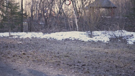 Drone landing in a snowy park.