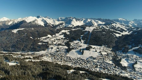 Drone view of snow covered town in the Alps.