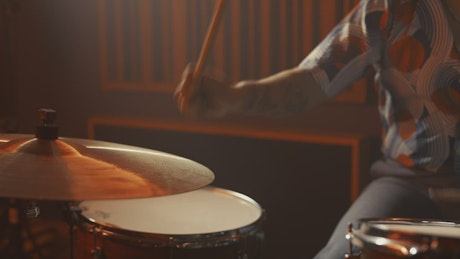 Drummer playing drums on a recording