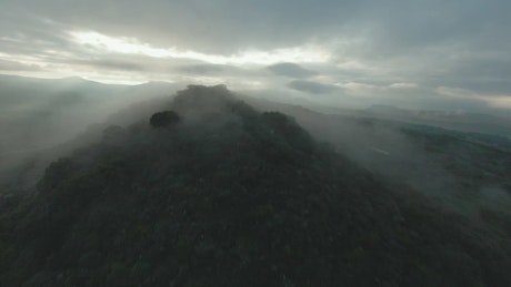 Dynamic drone aerial tour over a big hill.