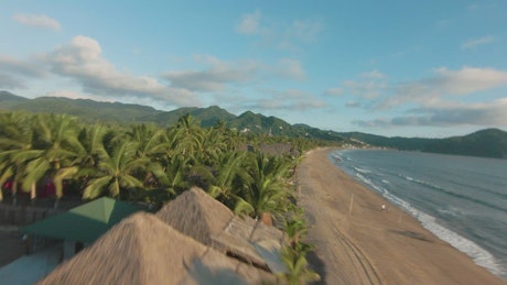 Dynamic drone tour through a beach.