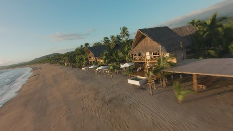 Dynamic drone video of a sunny beach.