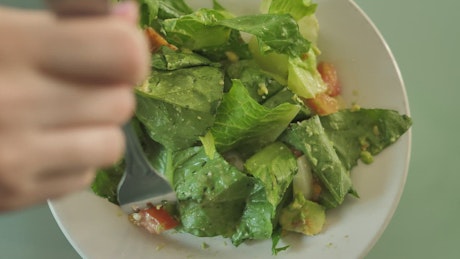 Eating salad with a fork