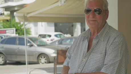 Elderly man wearing sunglasses.