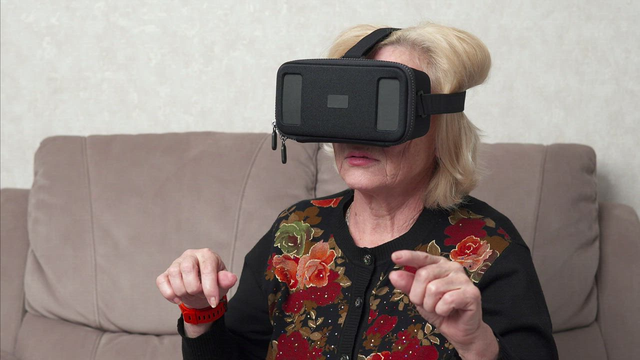 Elderly person using a VR headset Free Stock Video Mixkit