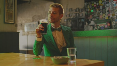 Elegant man in a bar on Saint Patrick's Day.