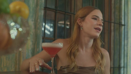 Elegant woman drinking a margarita during a date