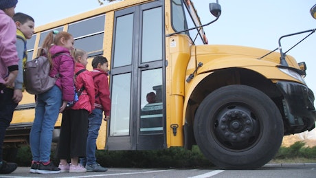 Elementary kids boarding the bus.