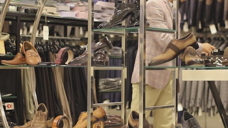 Employee working in a shoes store.