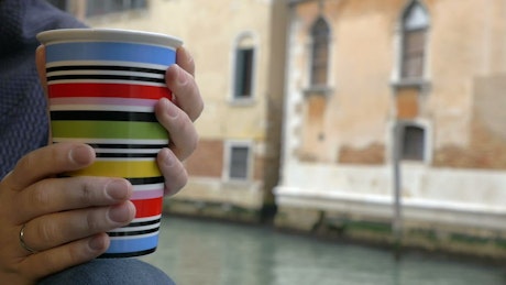 Enjoying a mug of tea by the river in Venice.