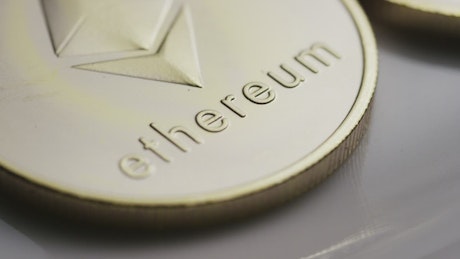 Ethereum in gold coins in a close-up shot.