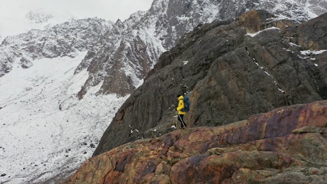 Explorer walking on top of a mountain