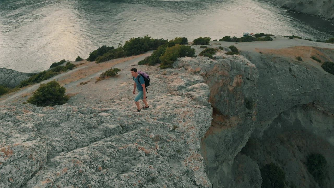 Exploring rocky shoreline and looking at horizon - Free Stock Video