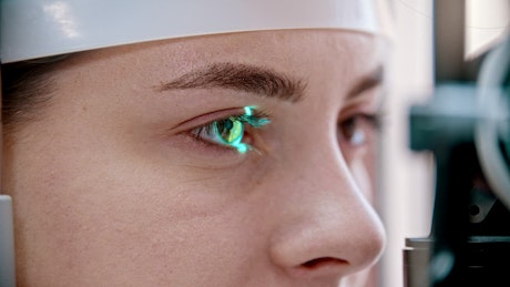 Eyes of a woman being checked by a vision device.