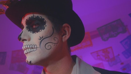 Face of a man disguised as a catrin on the day of the dead.