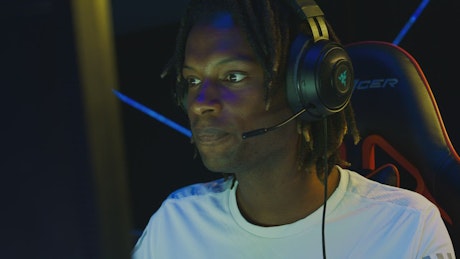 Face of a man playing on a gamer computer