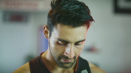 Face of a sweaty man in a gym.