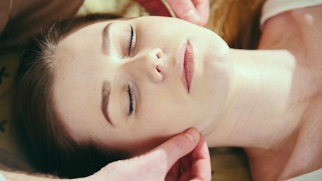 Face of a woman during a facial massage.