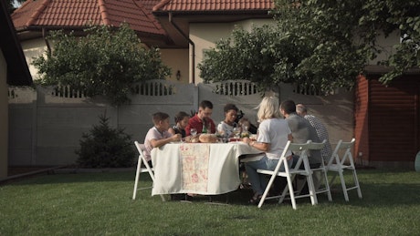 Family eating in the garden.