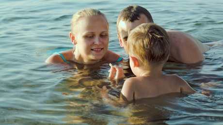Family playing in shallow water