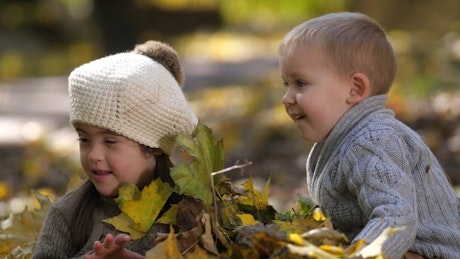 Family playing in the Autumn leaves.